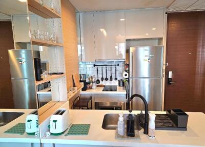 Modern kitchen with stainless steel appliances and clean countertop