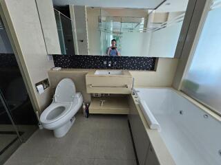 Modern bathroom with large bathtub, sink, and toilet