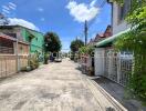 View of a residential street with colorful houses and greenery