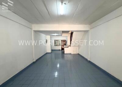 Spacious living room with tiled floor and staircase