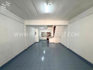 Spacious living room with tiled floor and staircase