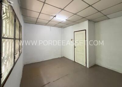 Empty room with tiled ceiling and window