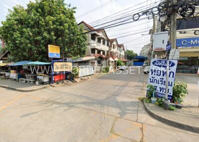 Street view of a neighborhood with buildings and small shops