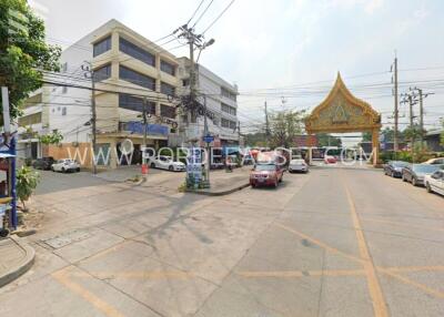 Street view of a commercial building and nearby area