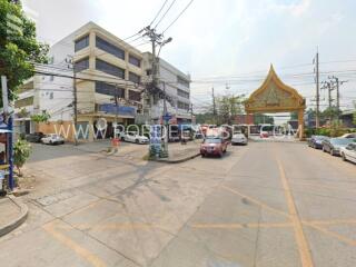 Street view of a commercial building and nearby area