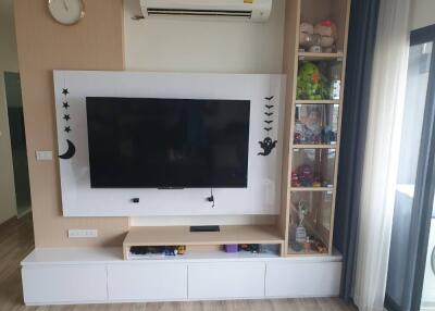 Living room with wall-mounted TV and display cabinet