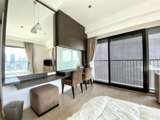 Spacious bedroom with large windows and city view