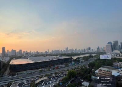 City skyline at sunset with river and buildings