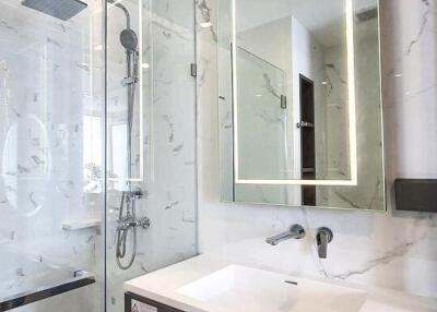 Modern bathroom with glass shower and illuminated mirror