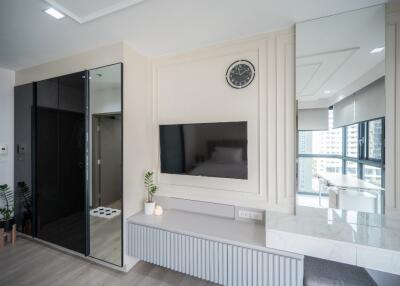 Modern living room with TV and large mirrors