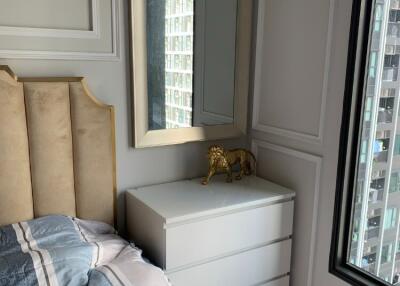 Bedroom with mirror, bed, and window view