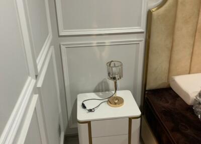 Nightstand with lamp in bedroom