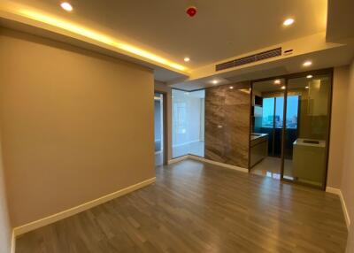 Spacious modern living area with wooden flooring and recessed lighting