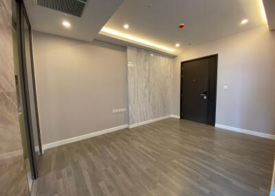 empty living room with wooden flooring and modern lighting