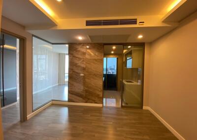 Modern living area with wooden flooring and large windows