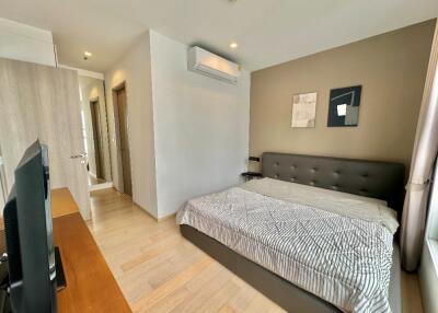 Modern bedroom with a large bed and wall-mounted air conditioning