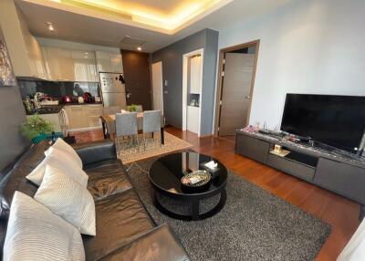 Living room with adjacent kitchen featuring a dining area