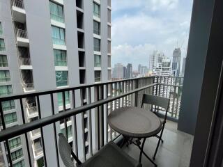 Balcony view with table and chairs overlooking cityscape