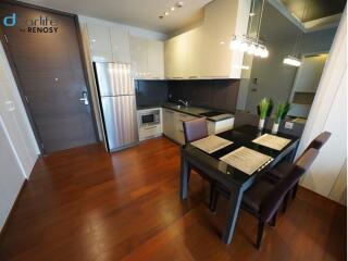 Modern kitchen with dining area and wooden flooring