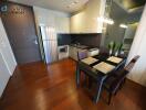 Modern kitchen with dining area and wooden flooring