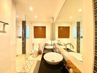 Modern bathroom with double sinks and large mirror