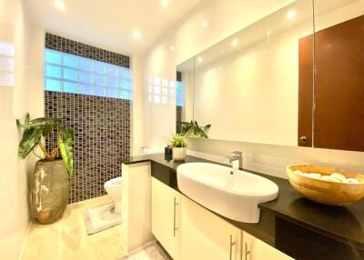 Modern bathroom with sleek fixtures and large mirror