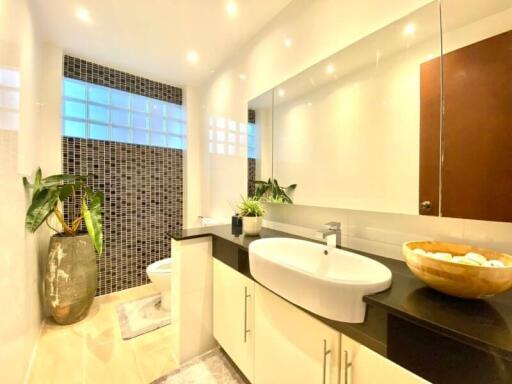 Modern bathroom with sleek fixtures and large mirror