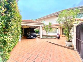 Front of the property with driveway and garden