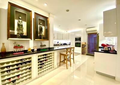 Modern kitchen with white cabinetry and wine storage