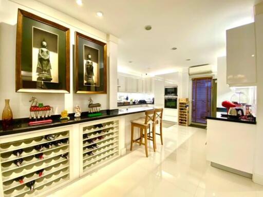 Modern kitchen with white cabinetry and wine storage