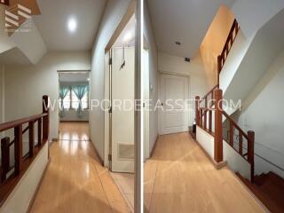 Hallway with wooden flooring and staircase