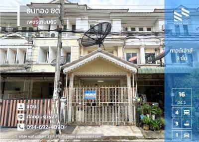 Front view of a three-story residential building with fenced entrance and satellite dishes