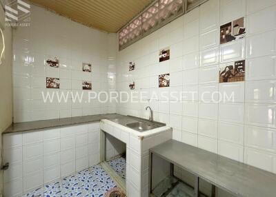 Kitchen with tiled backsplash and stainless steel sink