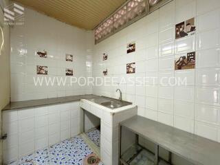 Kitchen with tiled backsplash and stainless steel sink