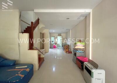 Living room with stairway and various furnishings