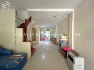 Living room with stairway and various furnishings