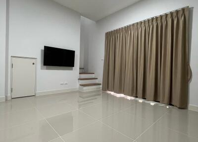 Modern living room with tiled floor and flat-screen TV