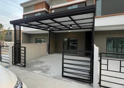 Modern residential townhouse with covered parking area