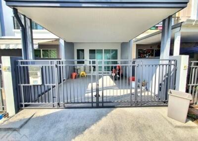 Front view of a residential building with a gated entry