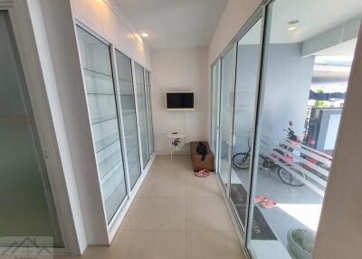 Modern hallway with shelving and large glass doors