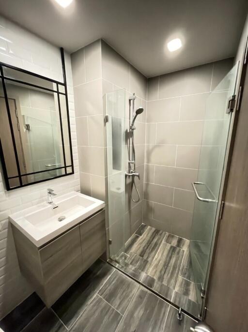 Modern bathroom with a walk-in shower and vanity