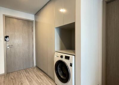 Laundry area with washing machine and storage cabinets