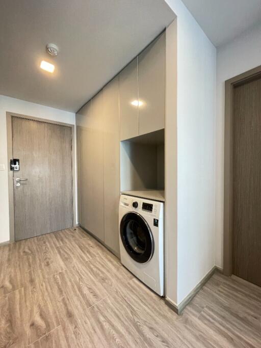 Laundry area with washing machine and storage cabinets