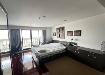 Master bedroom with large windows and modern furniture