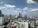 High-rise view of city buildings with river and cloudy sky