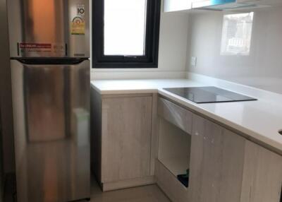 Modern kitchen with stainless steel fridge and built-in appliances