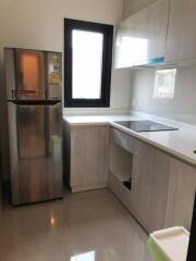 Modern kitchen with stainless steel fridge and built-in appliances