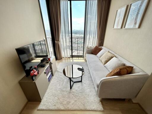 Modern living room with large window and city view