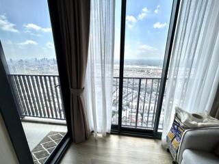 Living room with large windows and city view