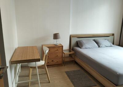 Bedroom with wooden furniture and a bed